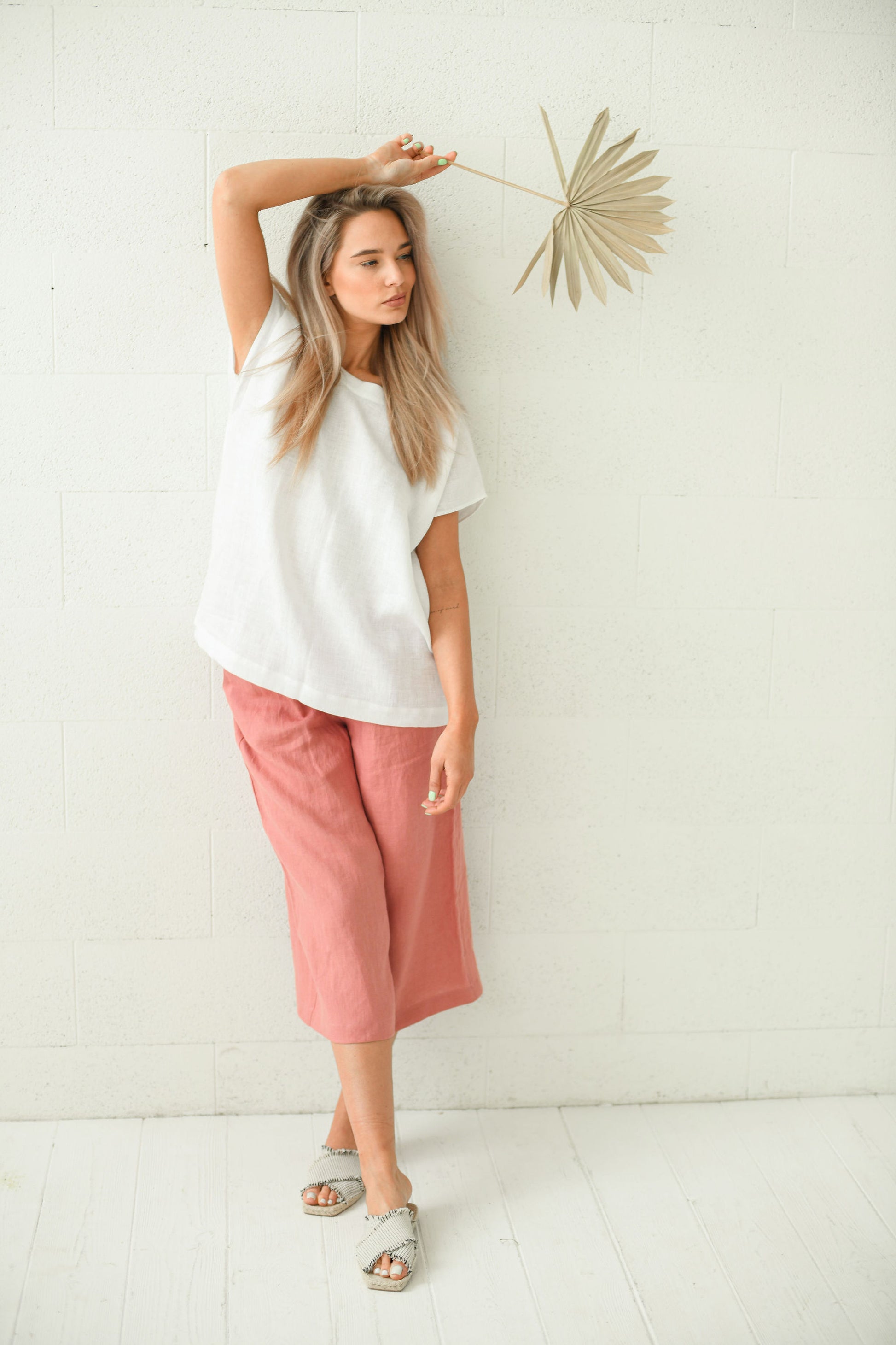 White linen top standing pose styled with pink culottes, handmade linen top slow fashion
