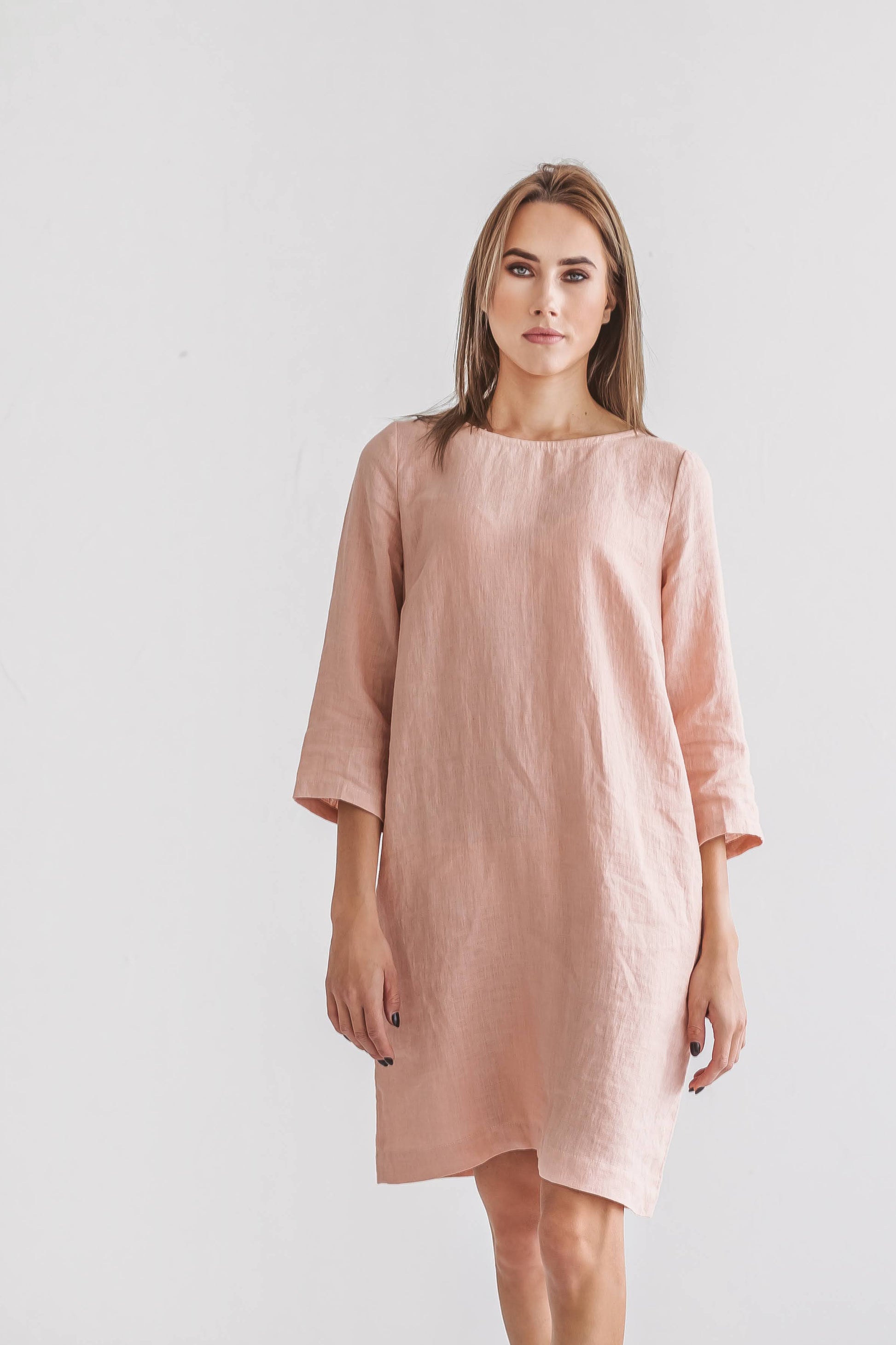 Woman wearing Melinda linen dress, smiling in studio