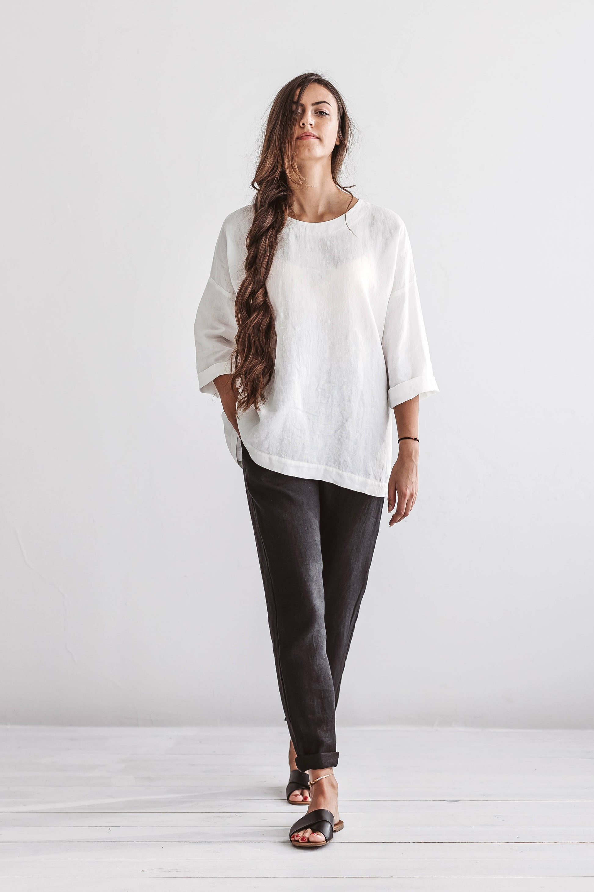 Black linen pants standing pose studio view showing relaxed fit, handmade linen pants slow fashion