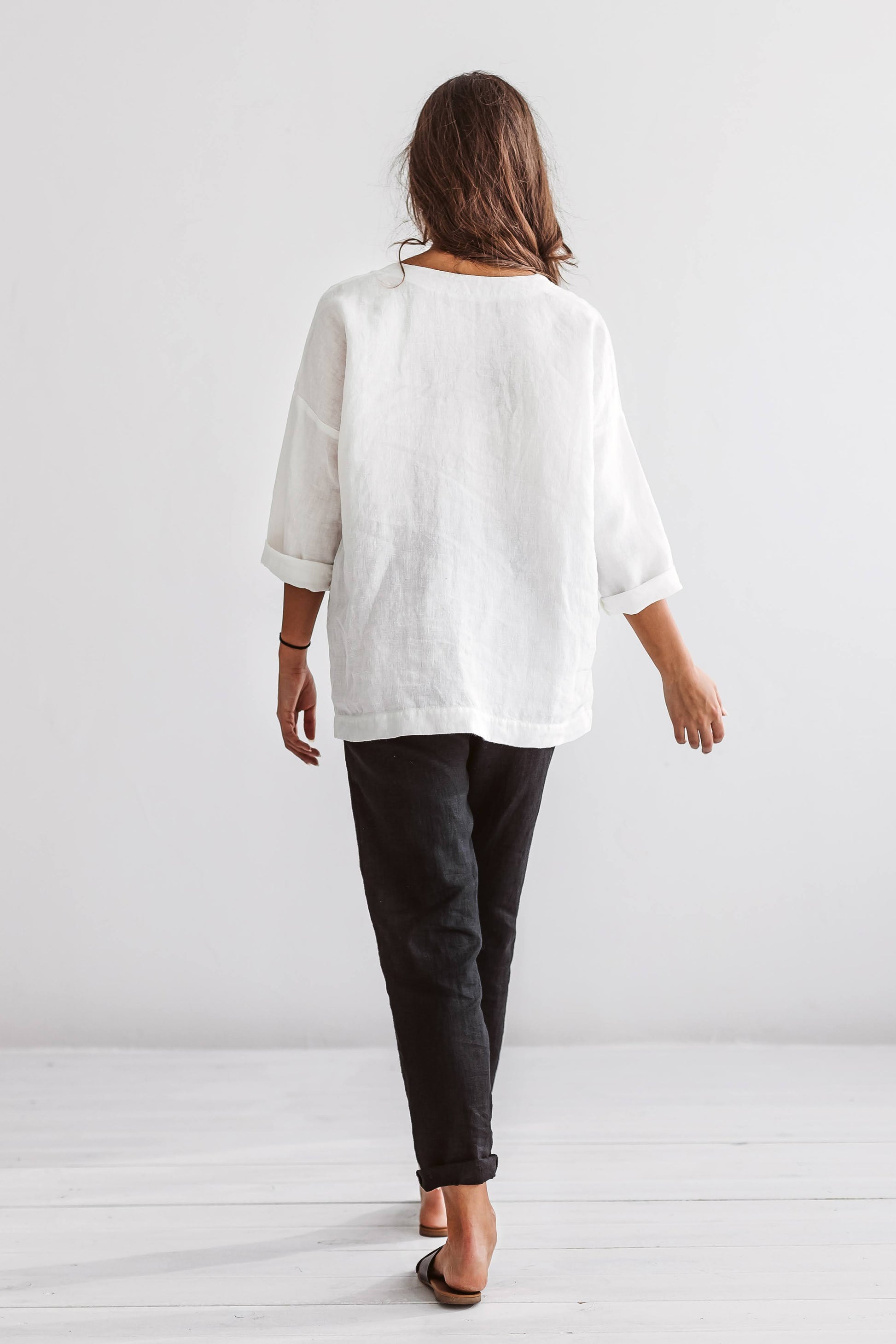 Black linen pants full-body studio back view showing straight-leg design, handmade linen pants slow fashion