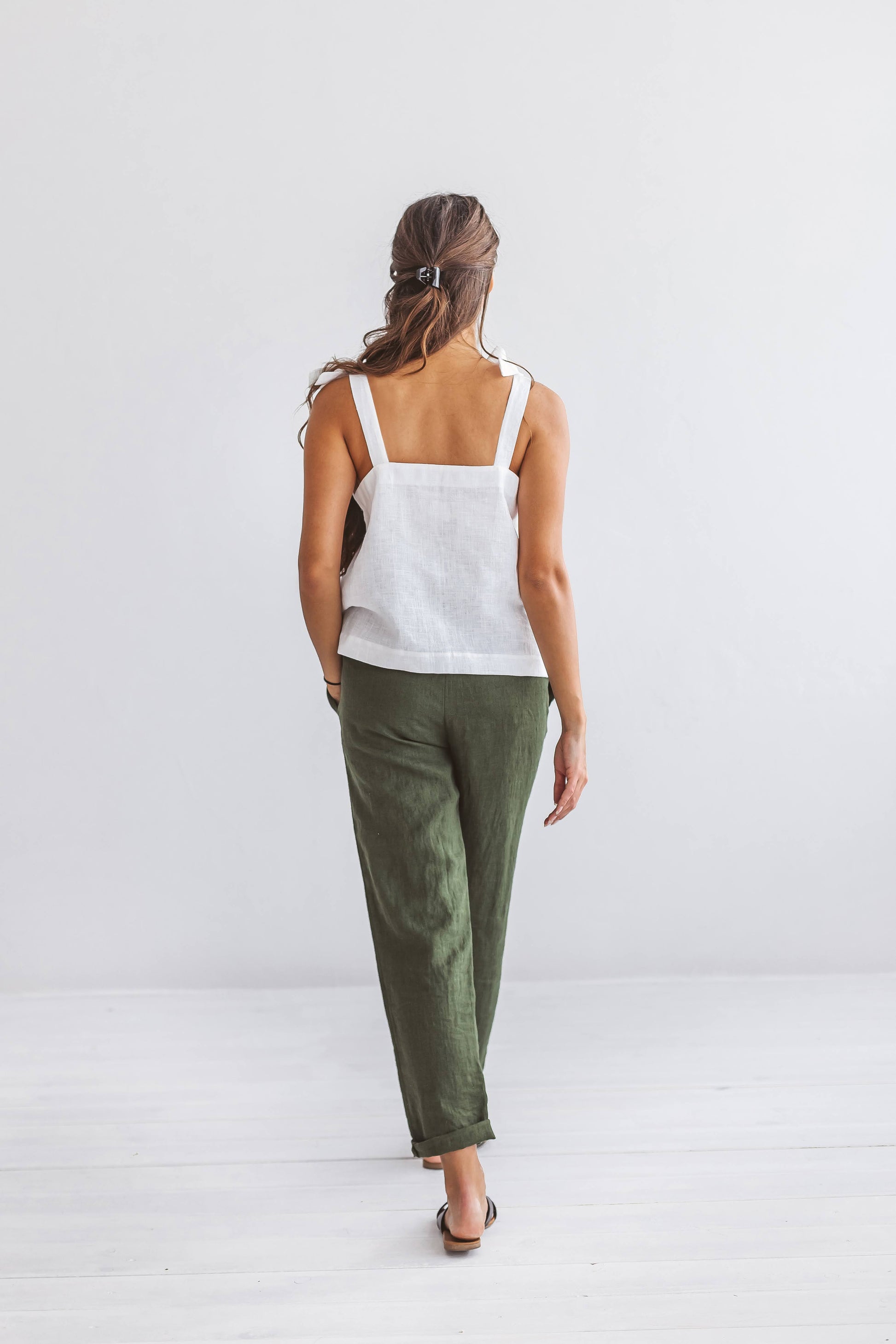 Forest green linen pants back view studio showing relaxed fit, handmade linen pants slow fashion