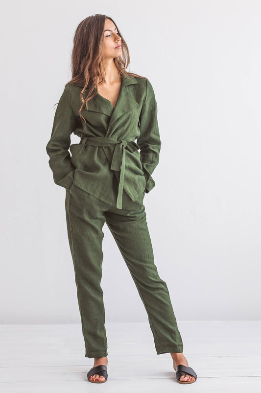 Forest green linen pants relaxed pose with hands in pockets minimal background, handmade linen pants slow fashion