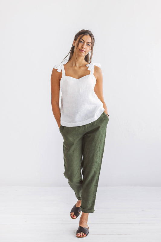 Forest green linen pants walking pose in studio showing relaxed fit, handmade linen pants slow fashion