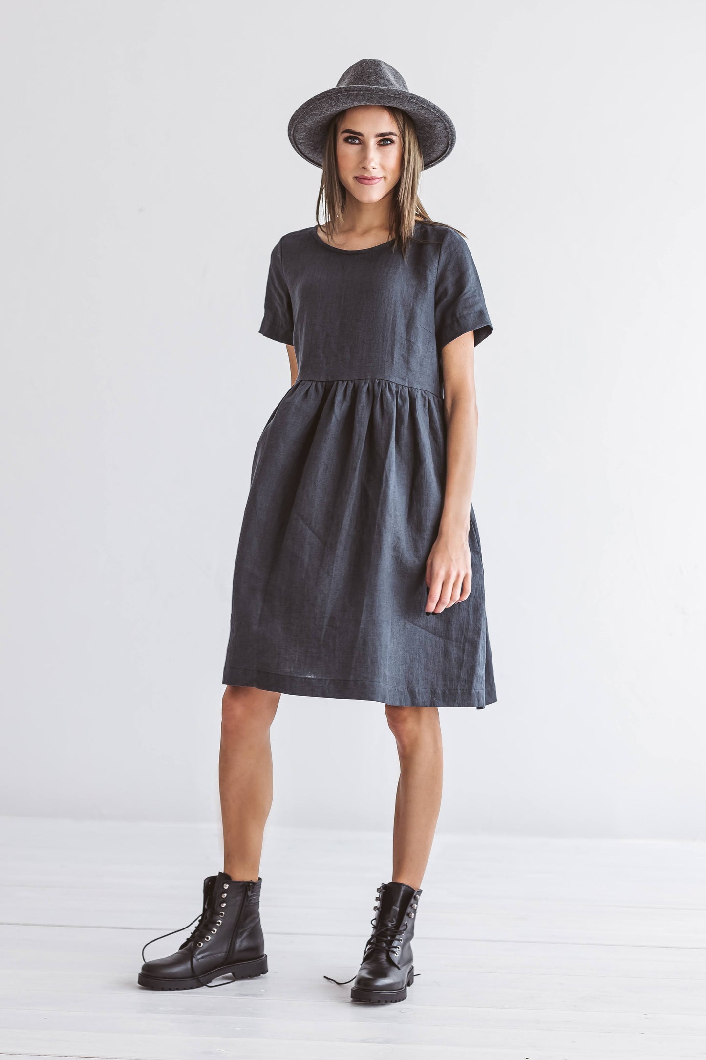 Graphite grey linen A-line dress standing in relaxed pose studio, handmade linen dress slow fashion