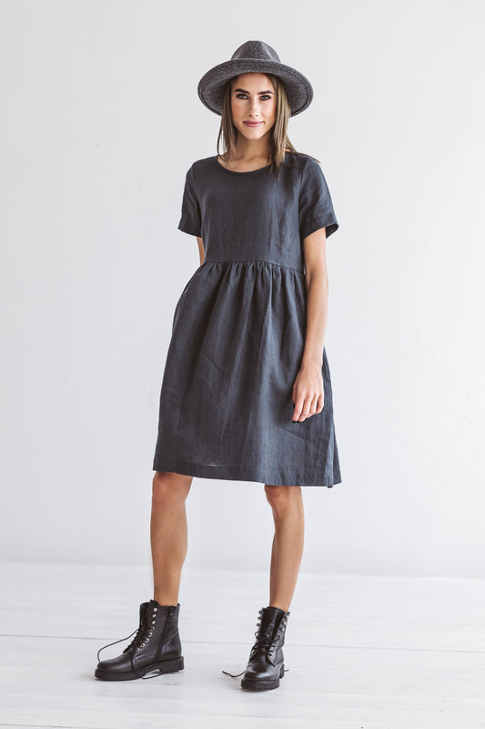 Graphite grey linen A-line dress standing in relaxed pose studio, handmade linen dress slow fashion