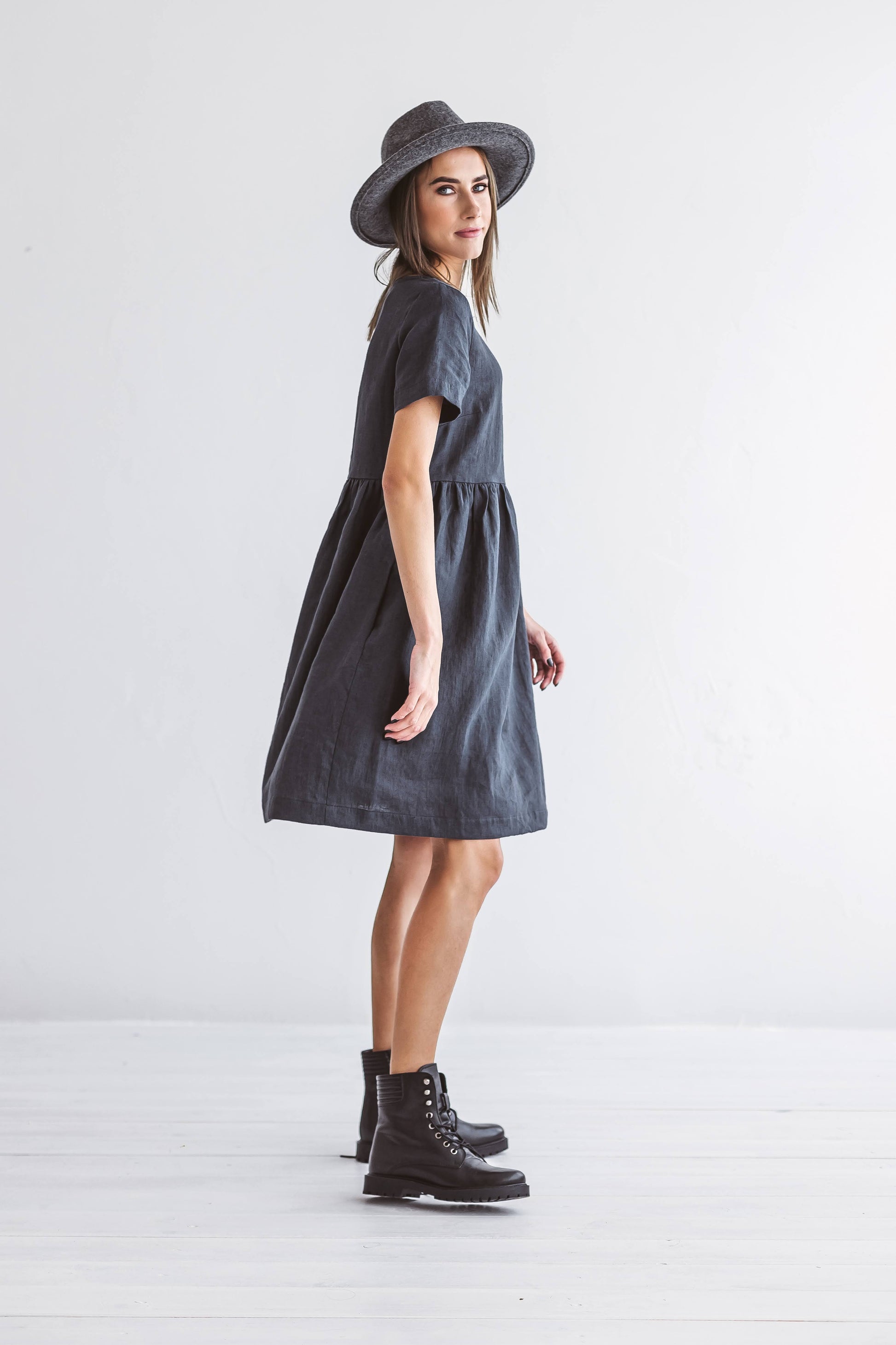 Graphite grey linen A-line dress side profile view showing minimalist silhouette, handmade linen dress slow fashion