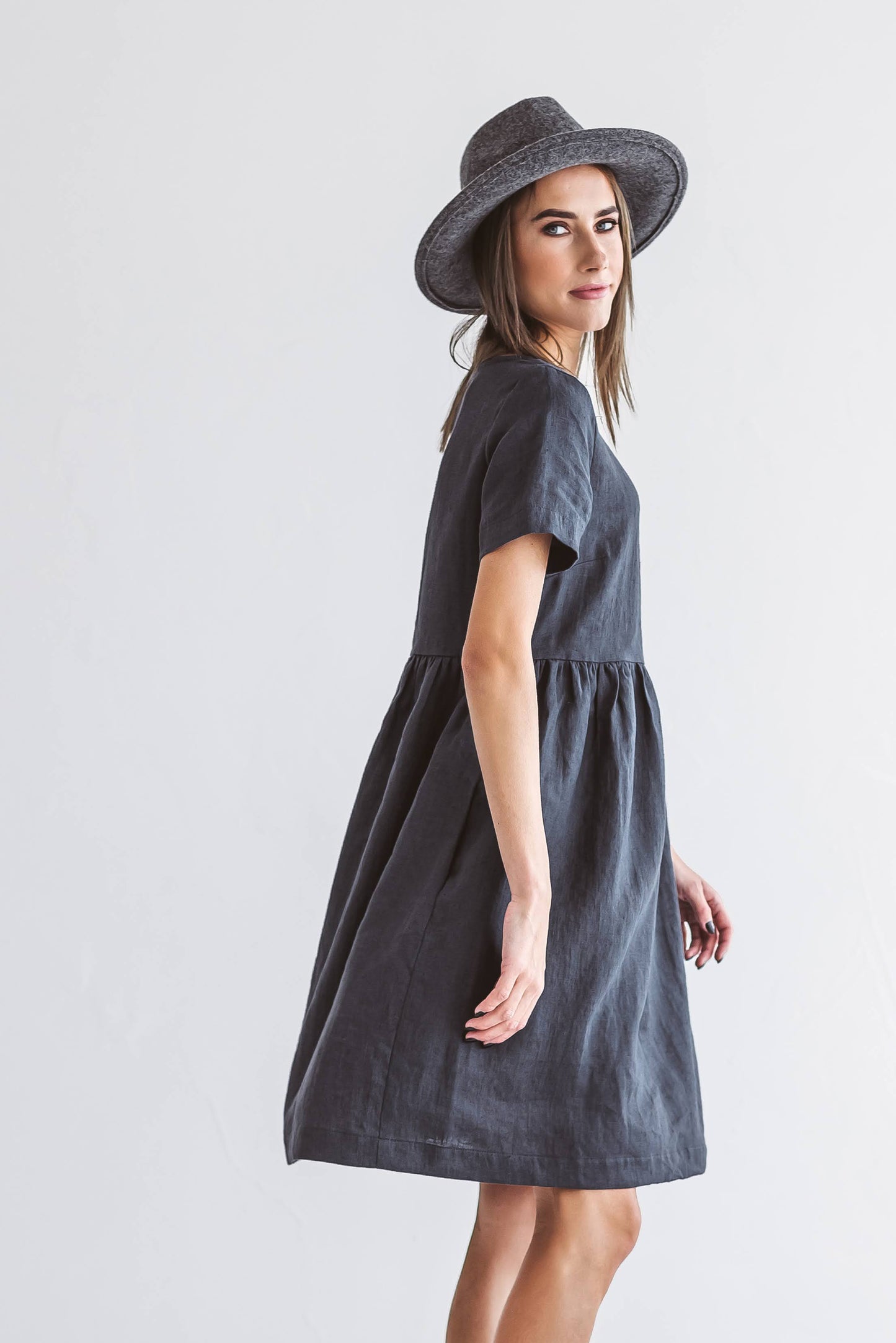 Graphite grey linen A-line dress side profile with hat showing relaxed fit, handmade linen dress slow fashion
