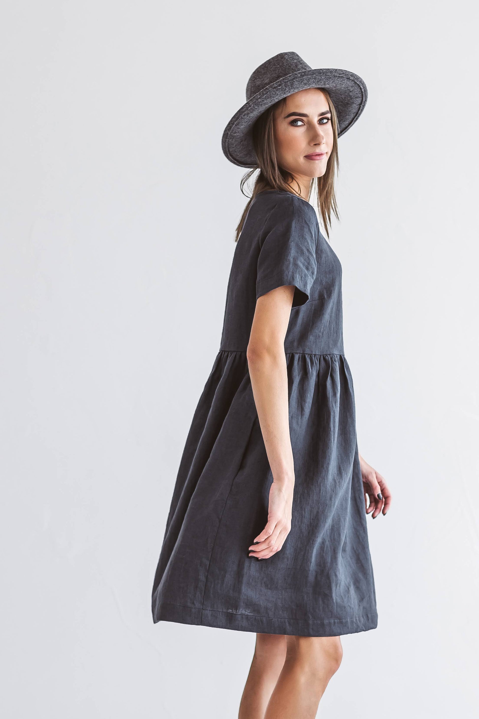 Graphite grey linen A-line dress side profile with hat showing relaxed fit, handmade linen dress slow fashion