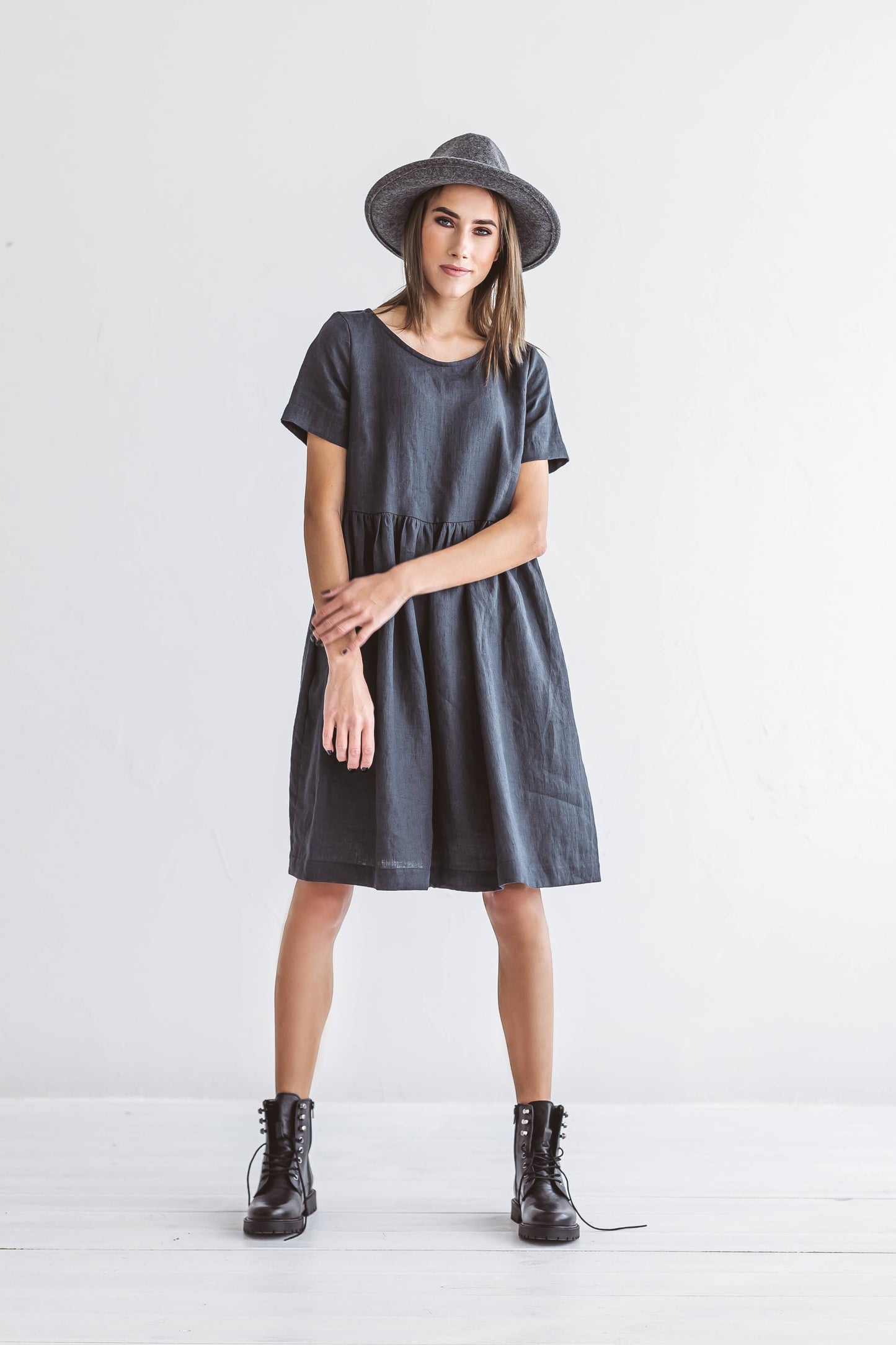 Graphite grey linen A-line dress walking forward showing soft drape movement, handmade linen dress slow fashion