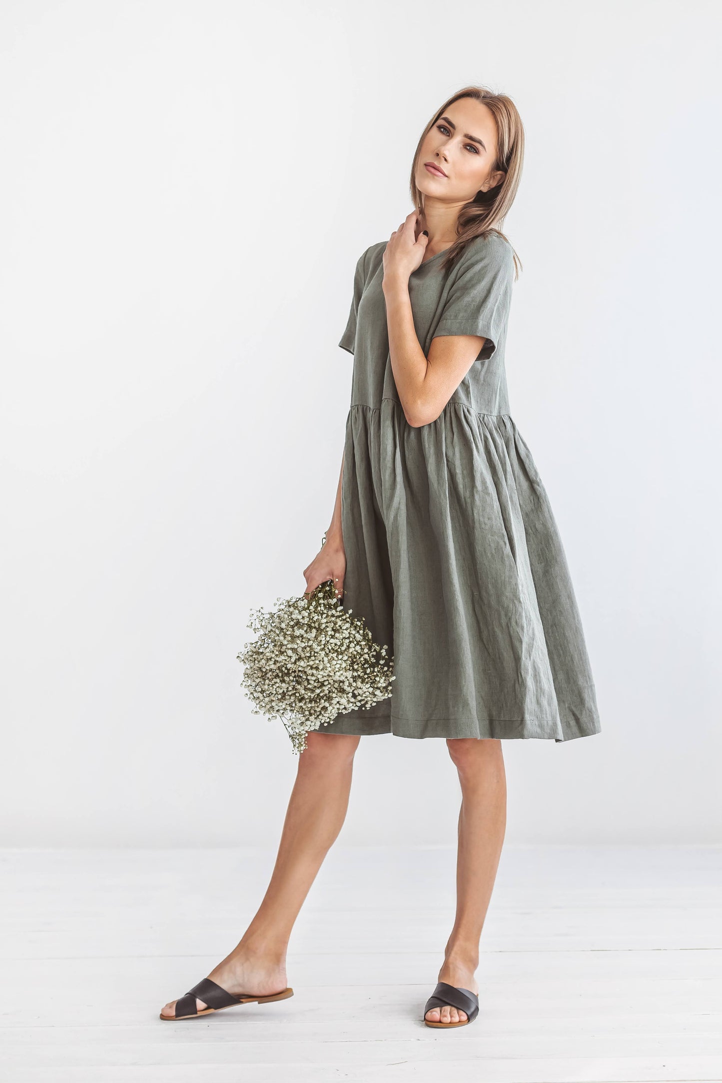Khaki linen A-line dress side profile view showing minimalist silhouette, handmade linen dress slow fashion