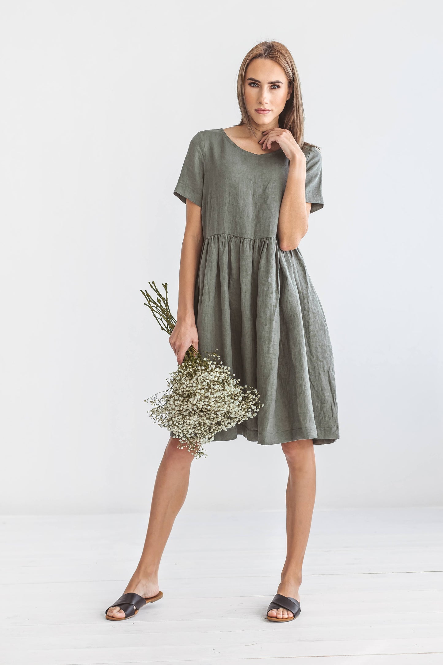 Khaki linen dress turning slightly with flowers showing soft drape, handmade linen dress slow fashion