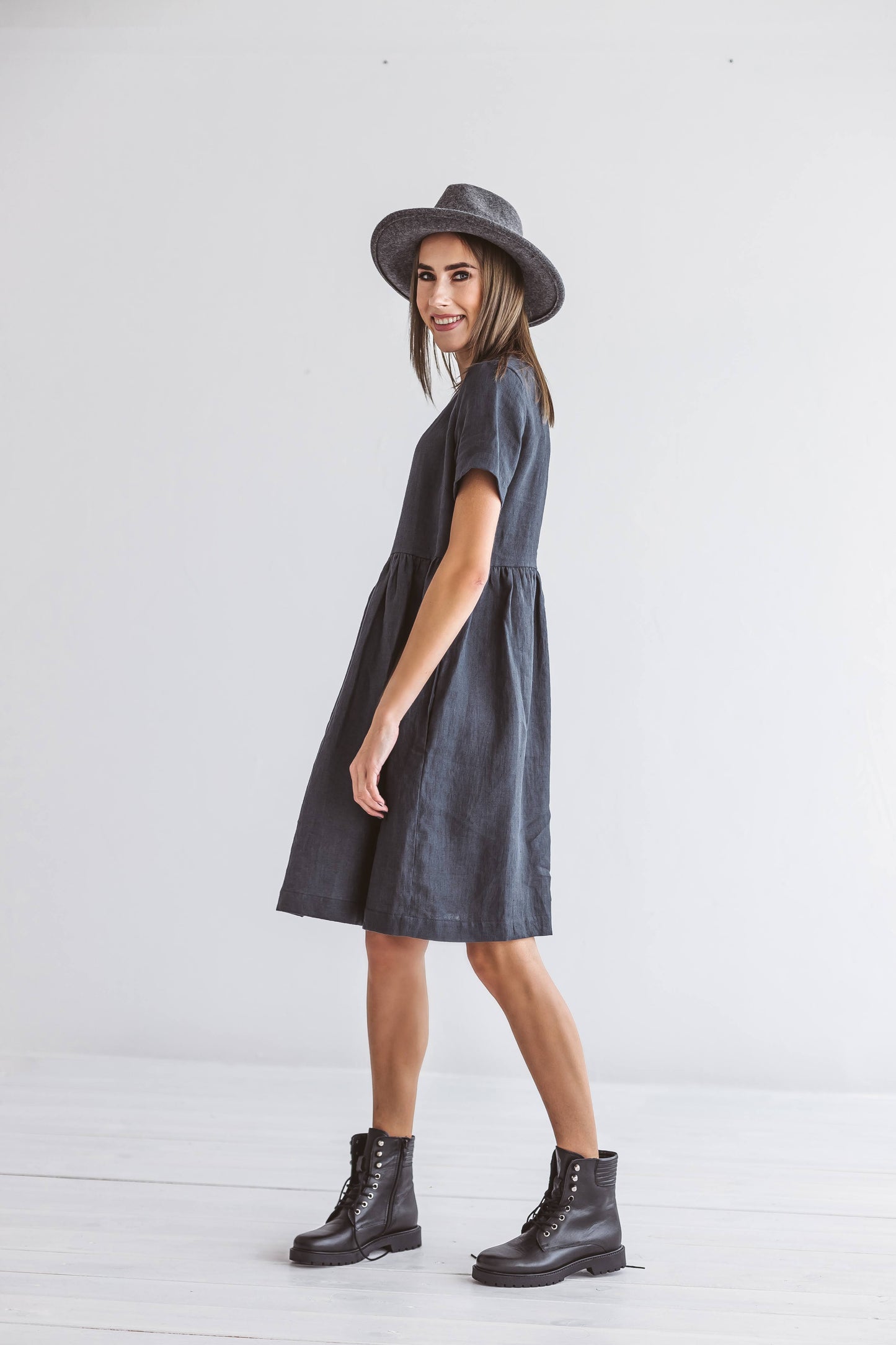 Graphite grey linen A-line dress photographed with hat accessory, handmade linen dress slow fashion