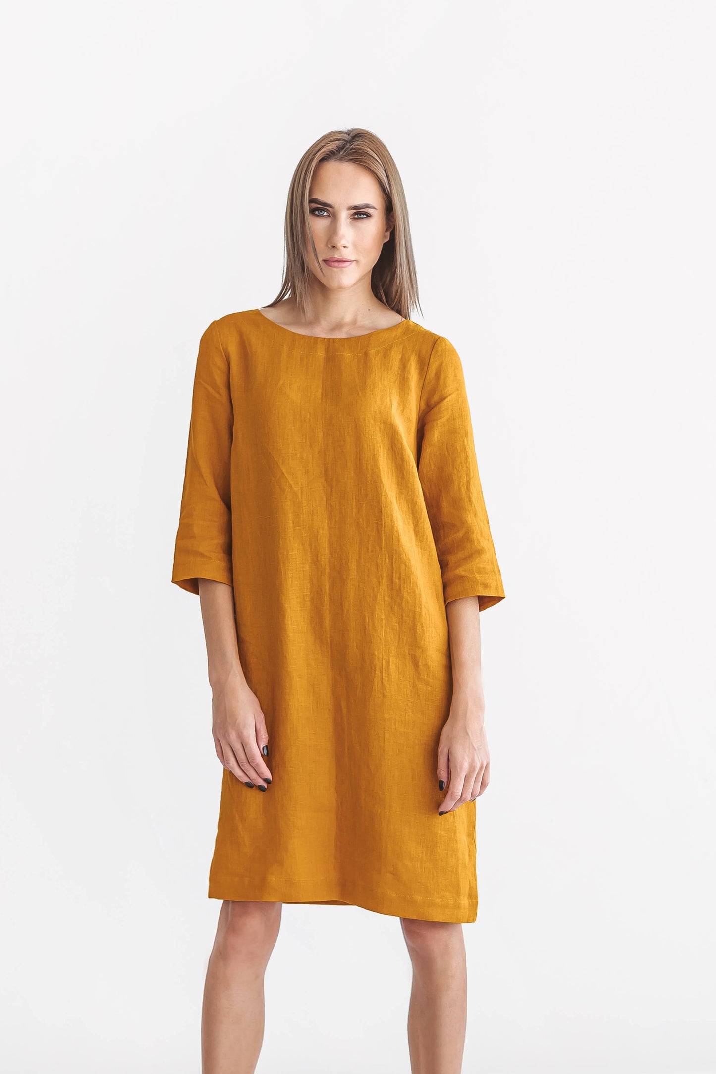Mustard linen dress front view standing against minimal background, handmade linen dress slow fashion