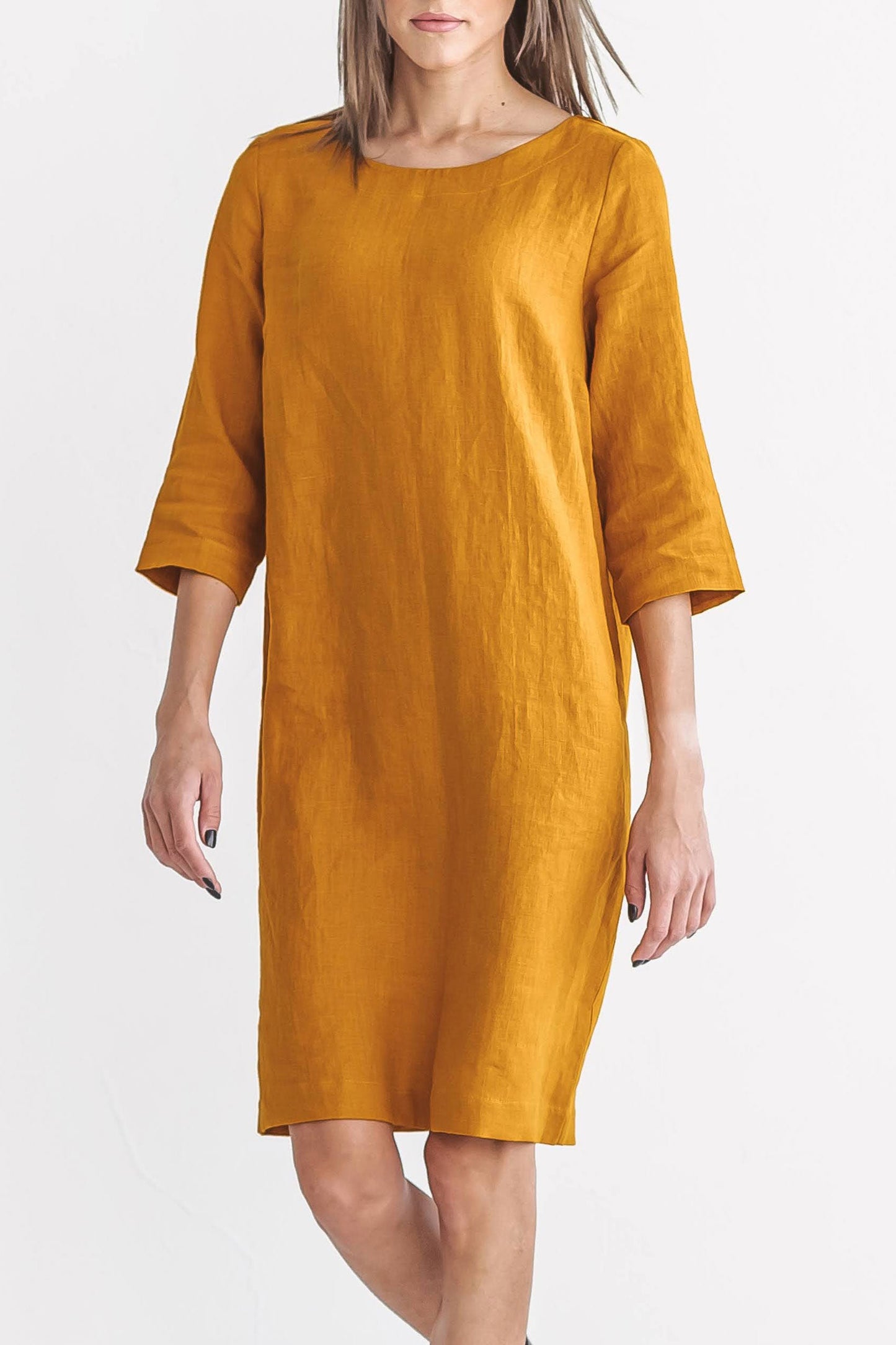 Mustard linen dress walking pose showcasing flow and movement, handmade linen dress slow fashion