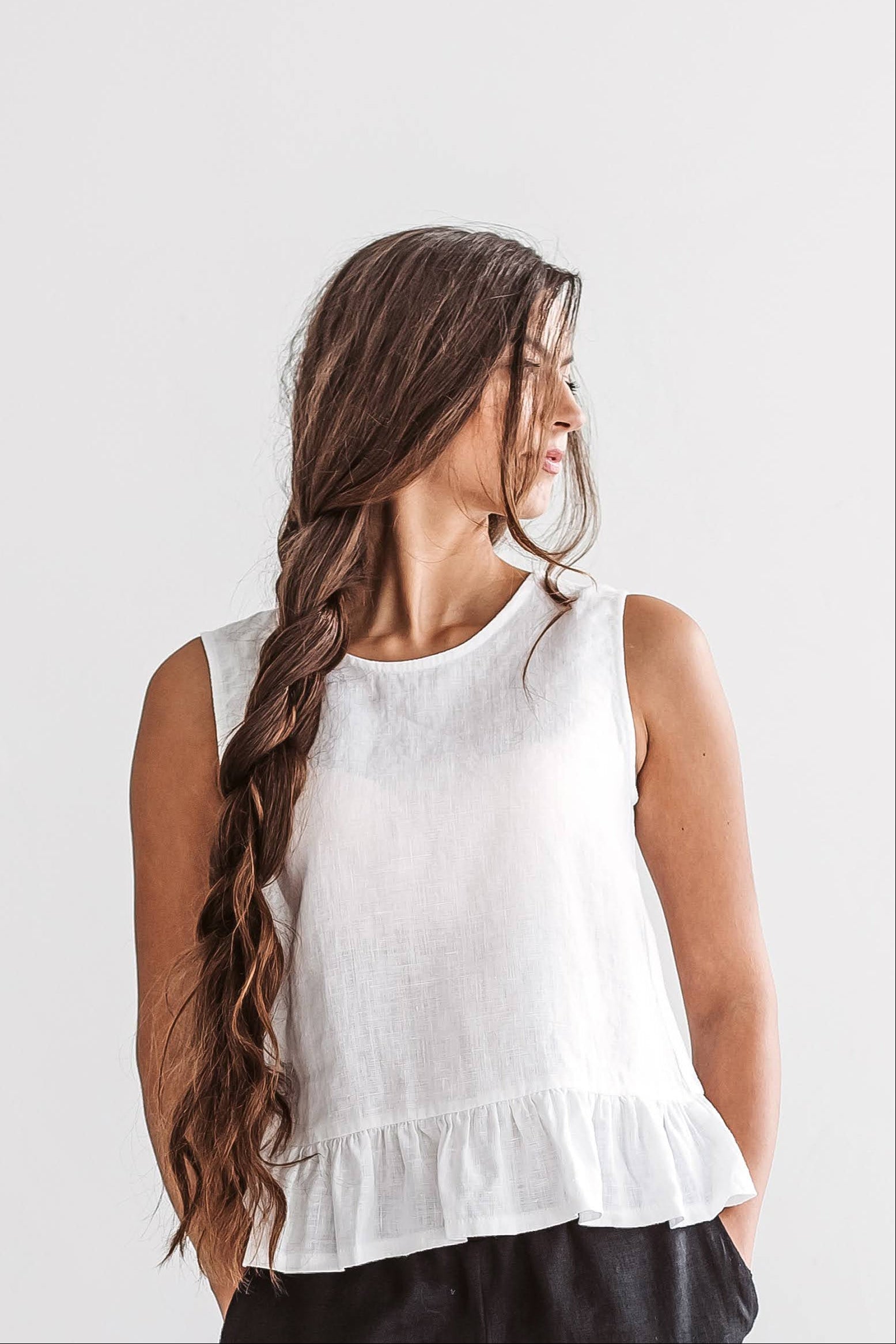 White linen top turning pose showcasing movement and relaxed shape, handmade linen top slow fashion