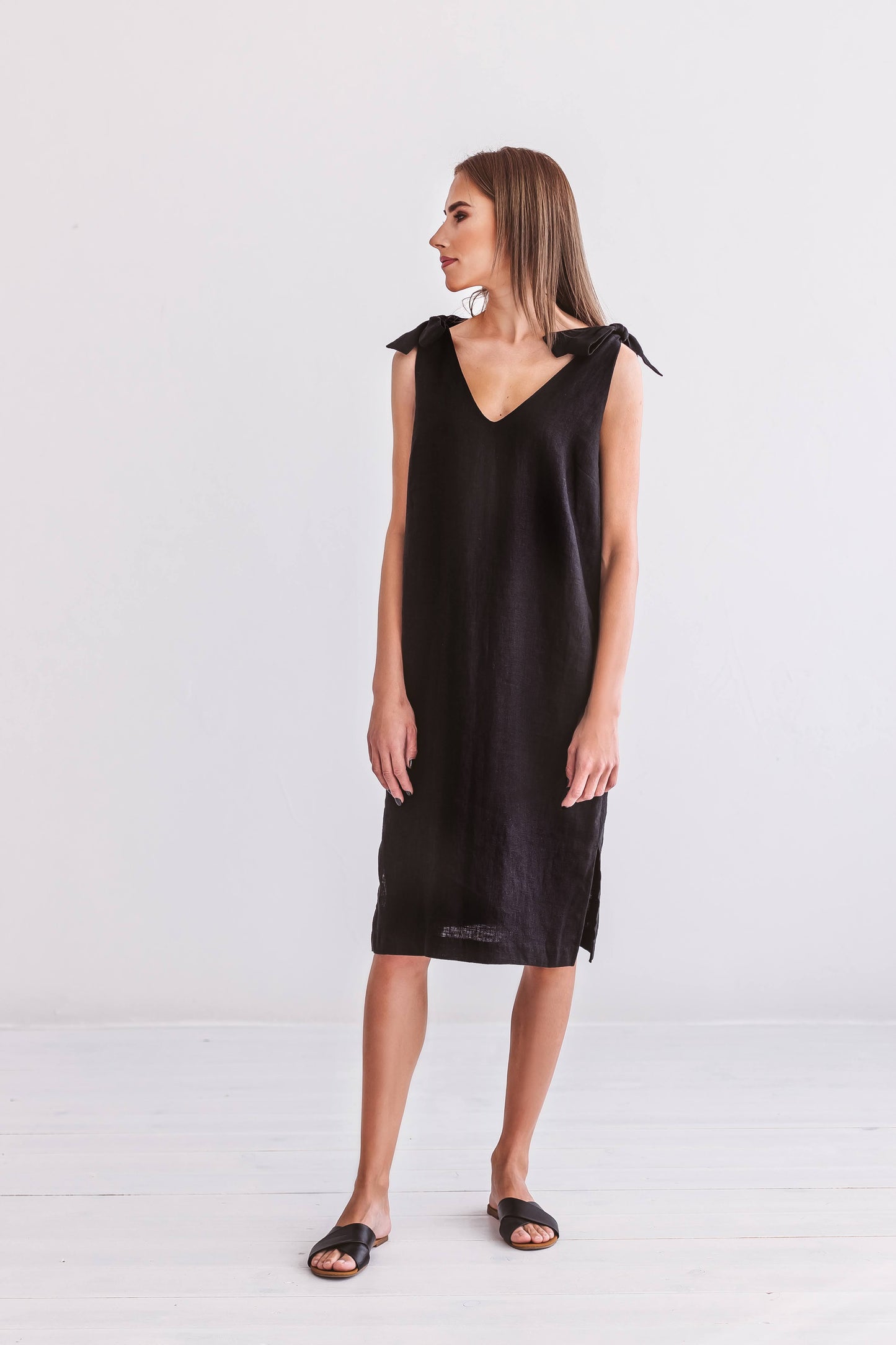 Black linen dress full-body view in relaxed pose showing sleeveless silhouette, handmade linen dress slow fashion