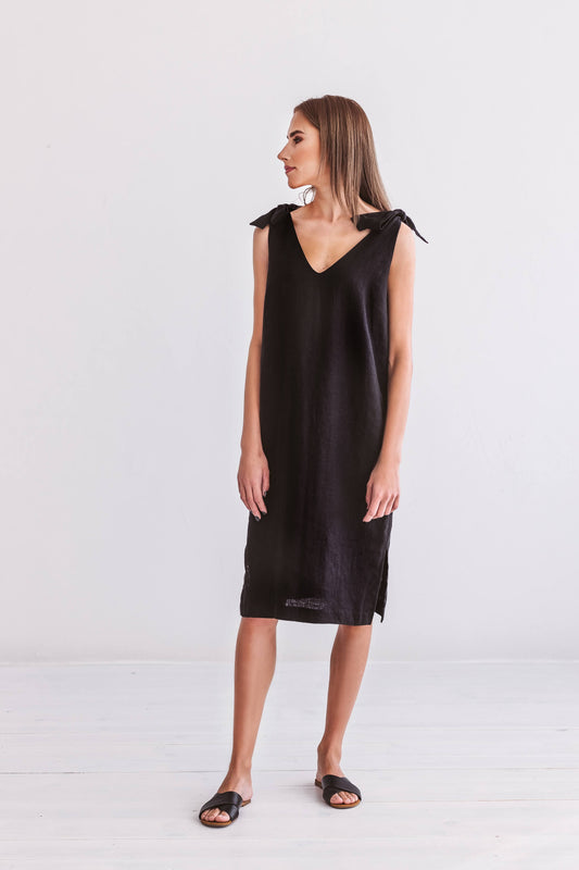 Black linen dress full-body view in relaxed pose showing sleeveless silhouette, handmade linen dress slow fashion