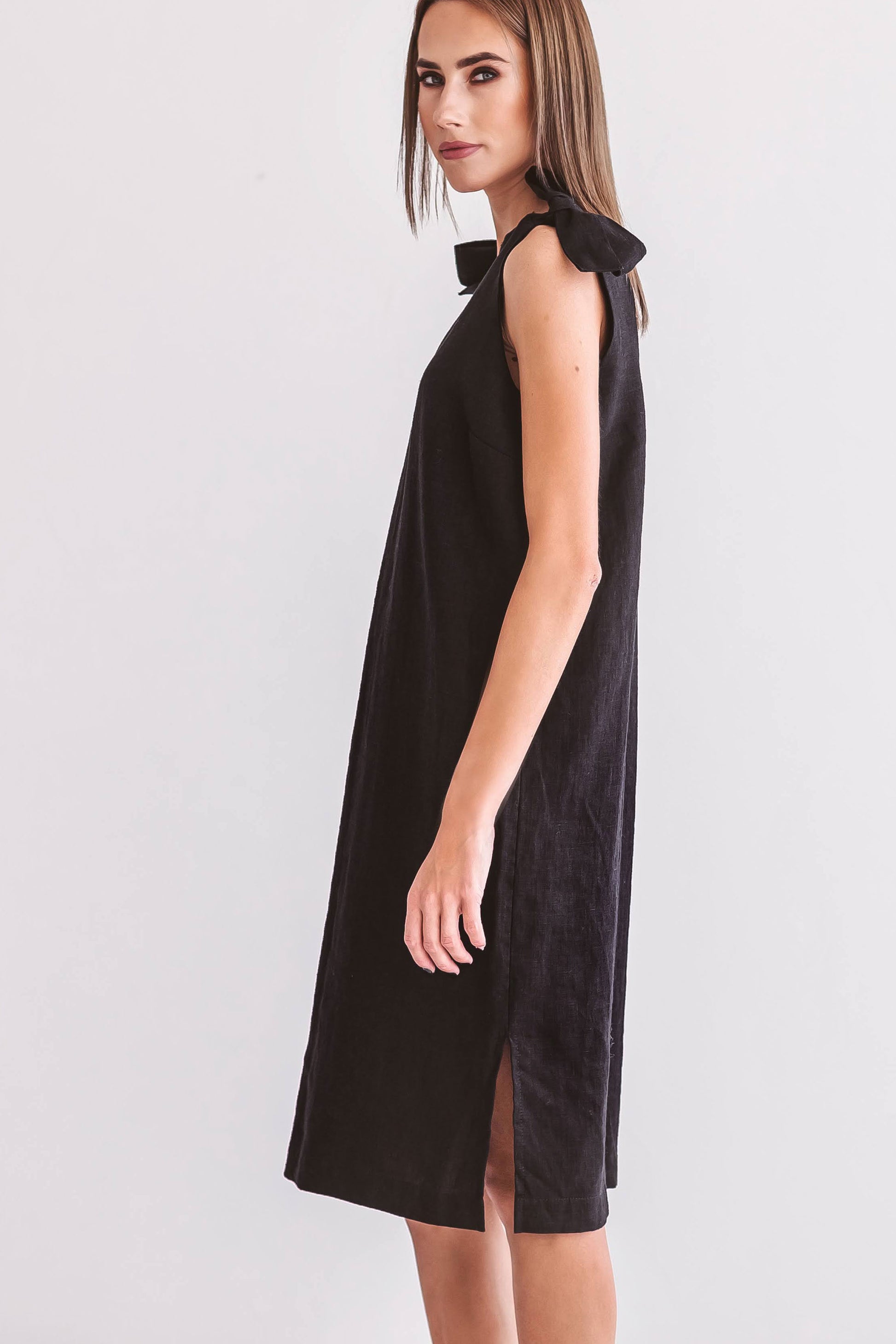 Black linen dress side angle smiling pose showing minimalist design, handmade linen dress slow fashion