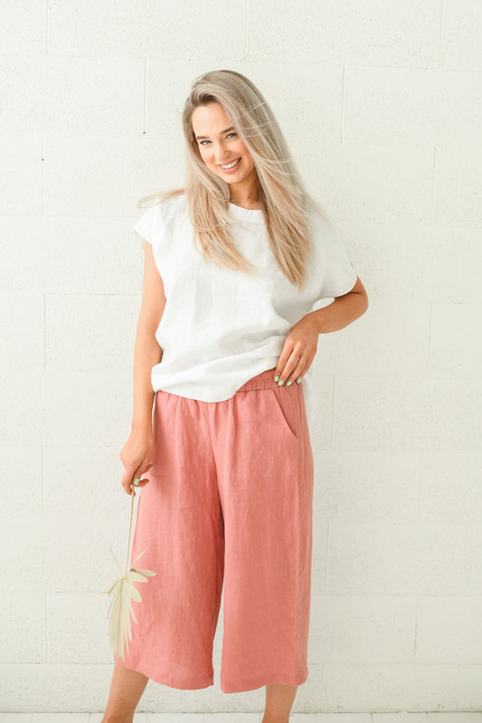 Salmon linen pants standing front-facing showing wide-leg silhouette, handmade linen pants slow fashion