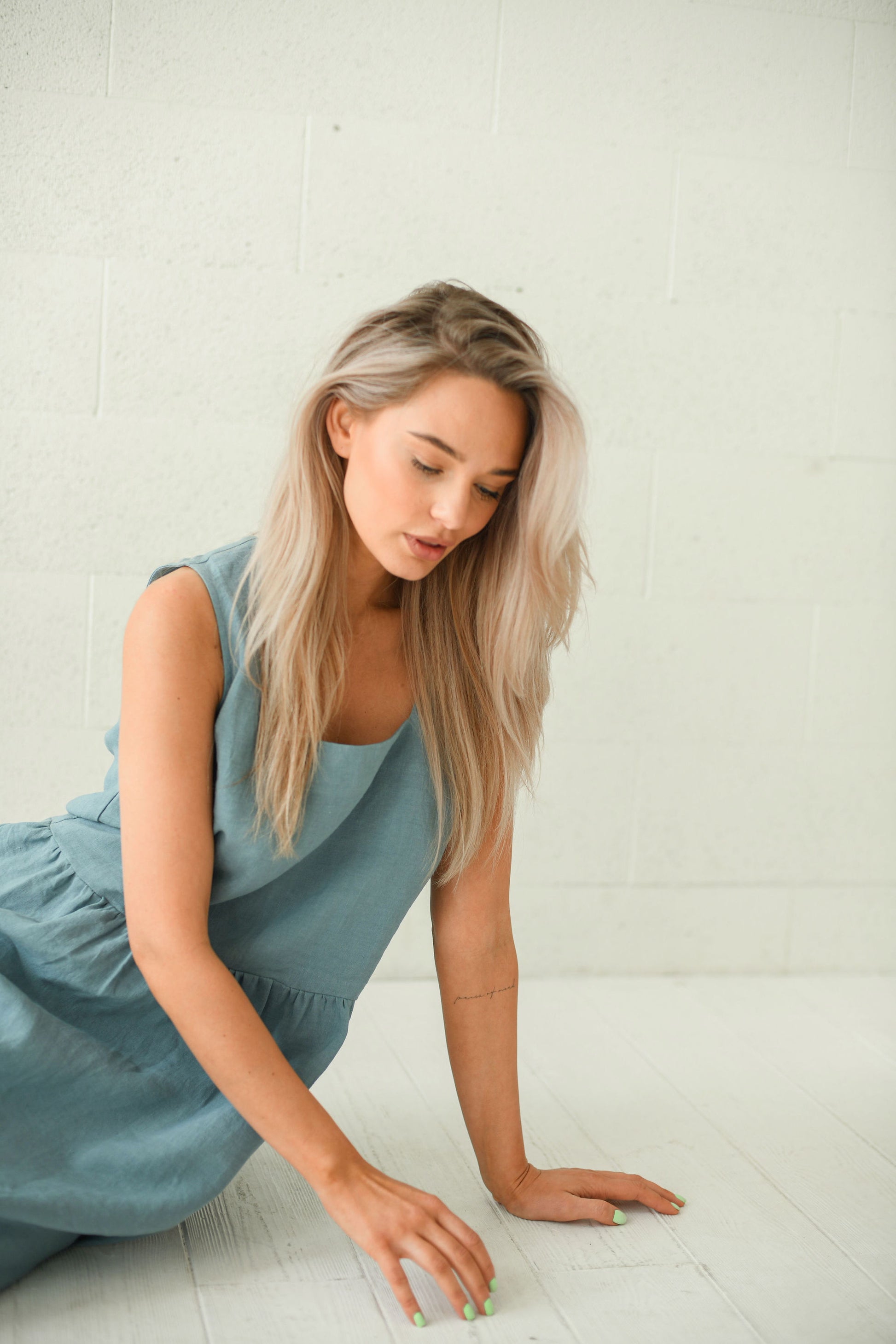 Dusty turquoise linen dress sitting pose showing comfortable relaxed fit, handmade linen dress slow fashion