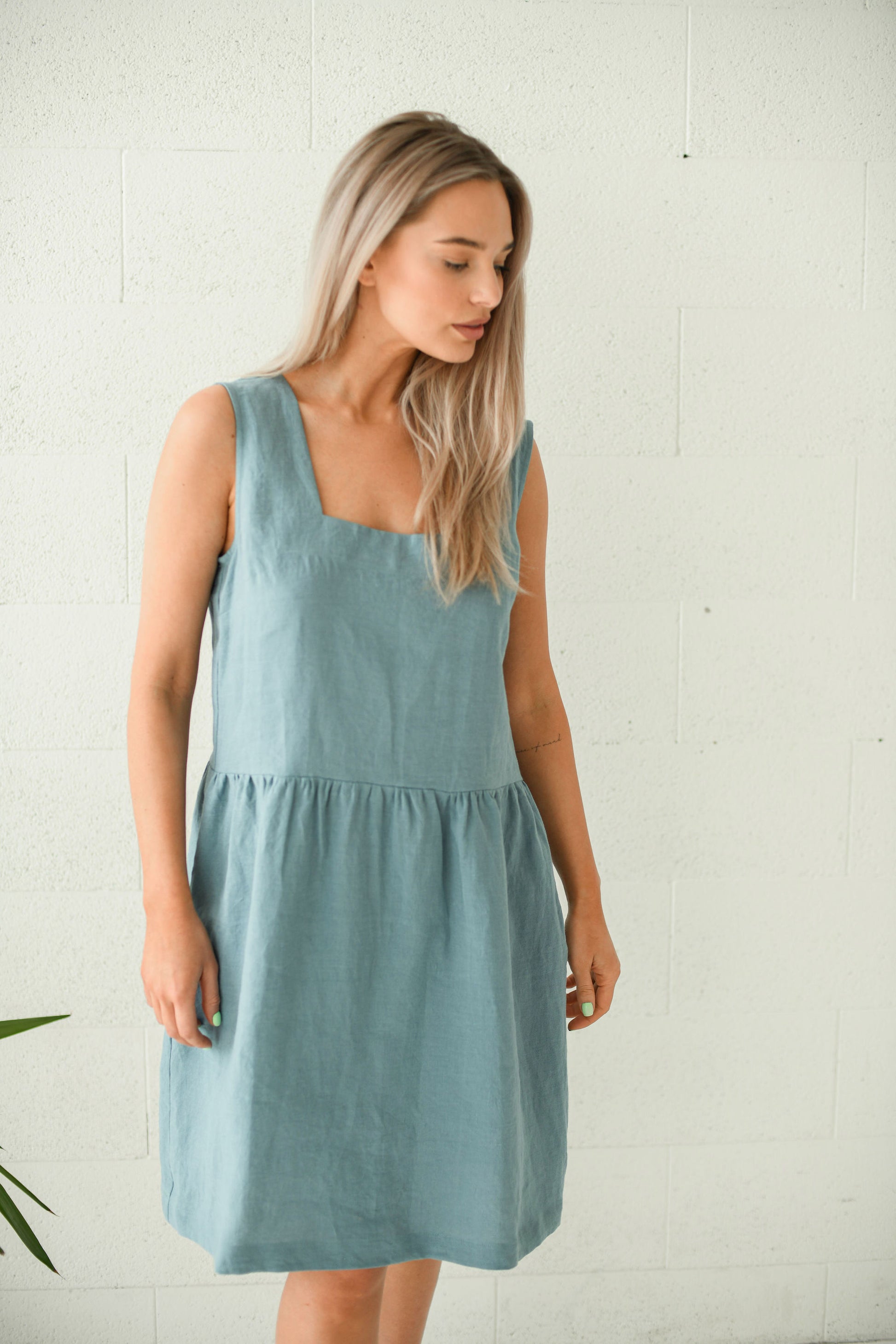 Dusty turquoise linen dress walking pose showing natural movement and flow, handmade linen dress slow fashion