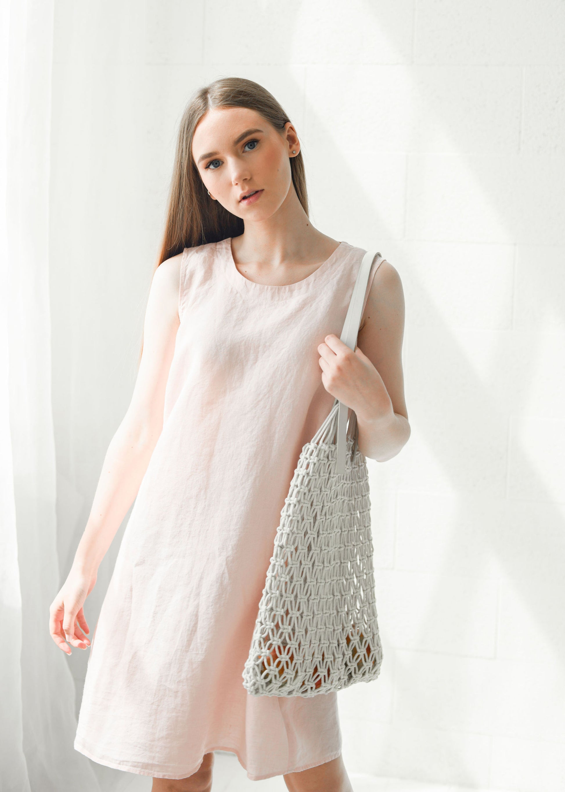 Dusty rose linen dress relaxed pose showing a-line silhouette, handmade linen dress slow fashion