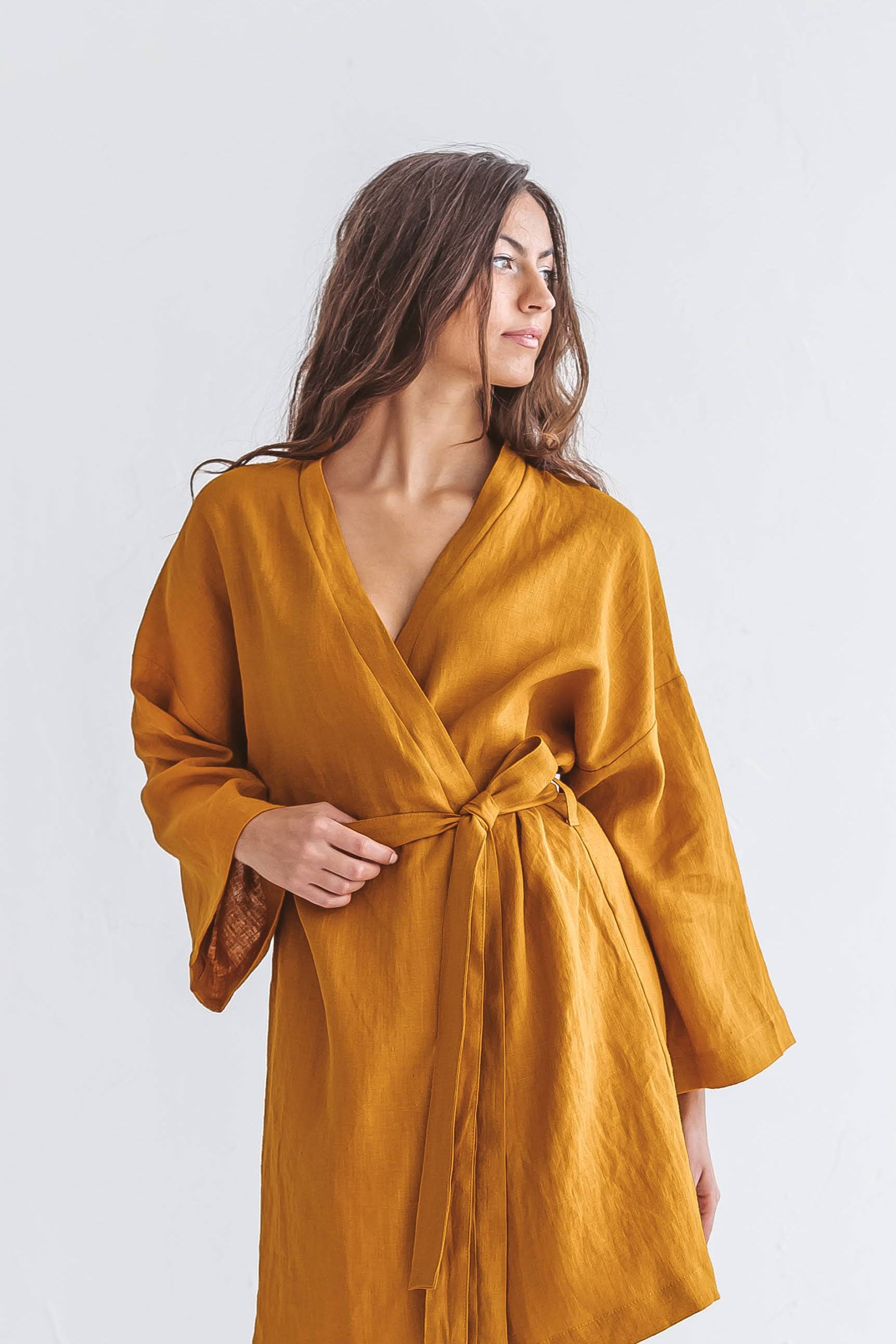 Mustard linen robe detail view showing craftsmanship and texture, handmade linen robe slow fashion