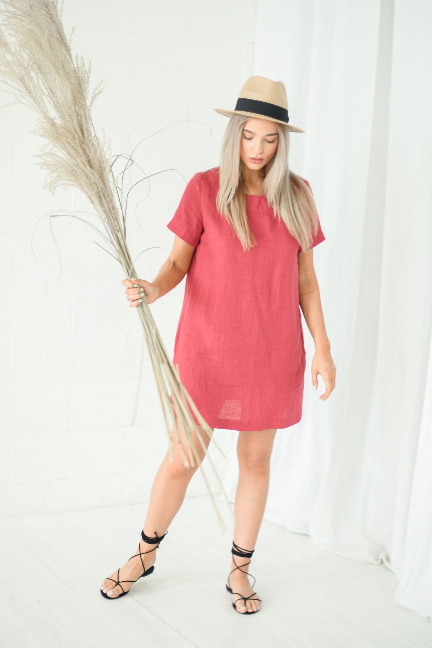 Dusty raspberry linen dress relaxed pose showing soft drape and short sleeves, handmade linen dress slow fashion