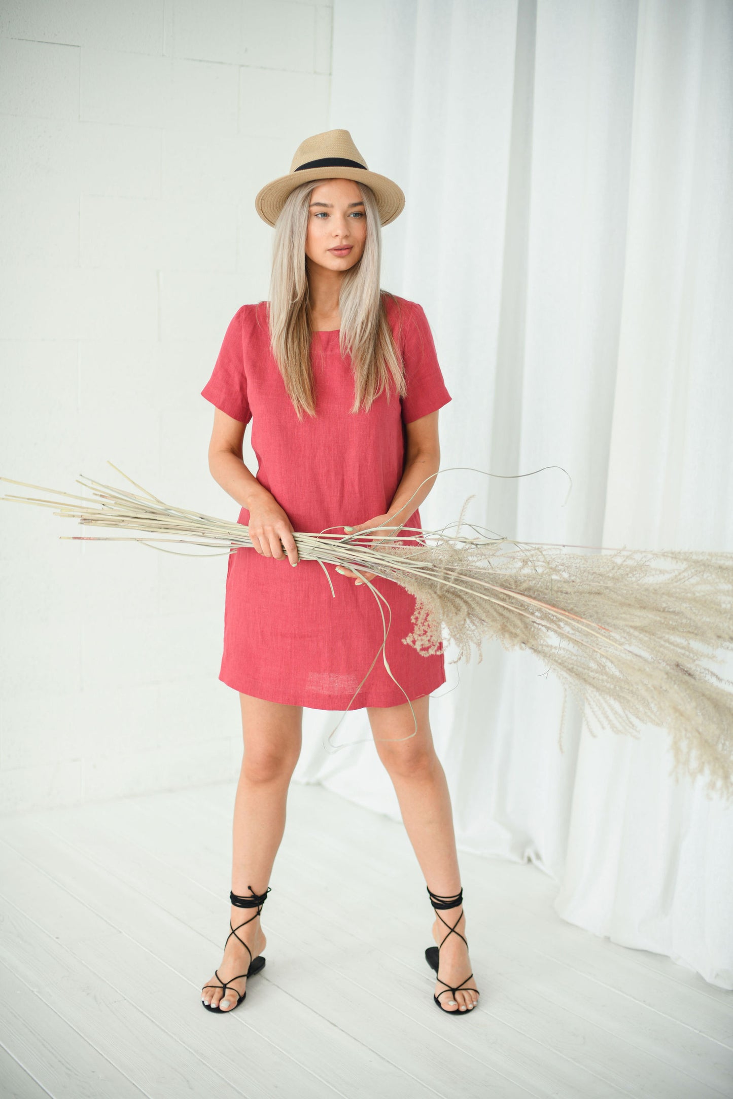 Dusty raspberry linen dress smiling pose showing square neckline and comfortable fit, handmade linen dress slow fashion