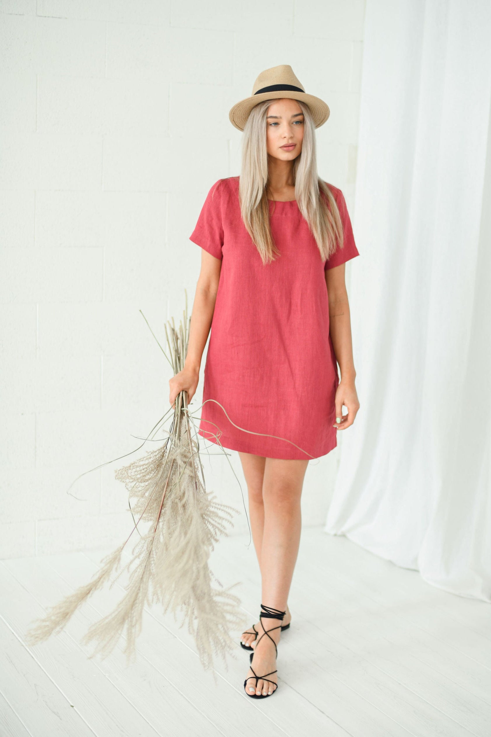 Dusty raspberry linen dress walking pose showing natural movement and mini length, handmade linen dress slow fashion
