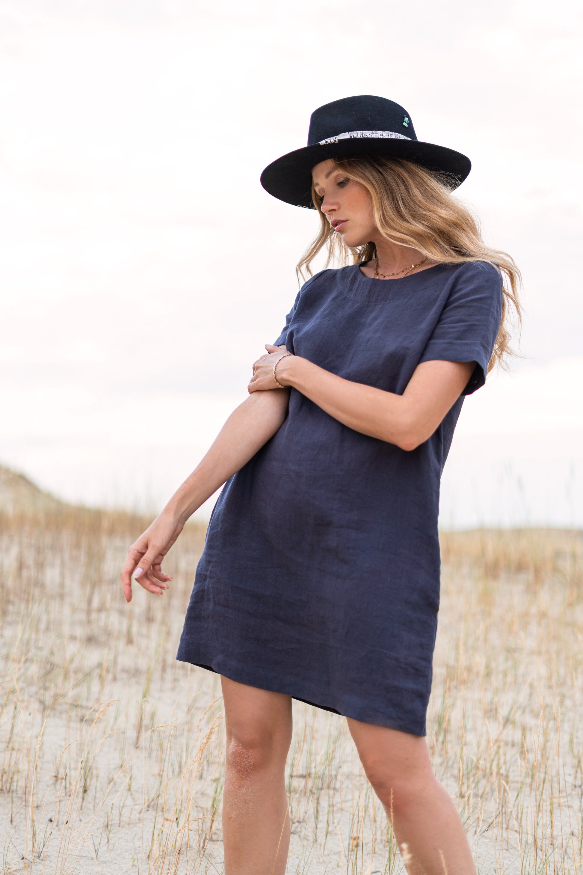 Graphite grey linen dress outdoor relaxed pose showing minimalist design, handmade linen dress slow fashion