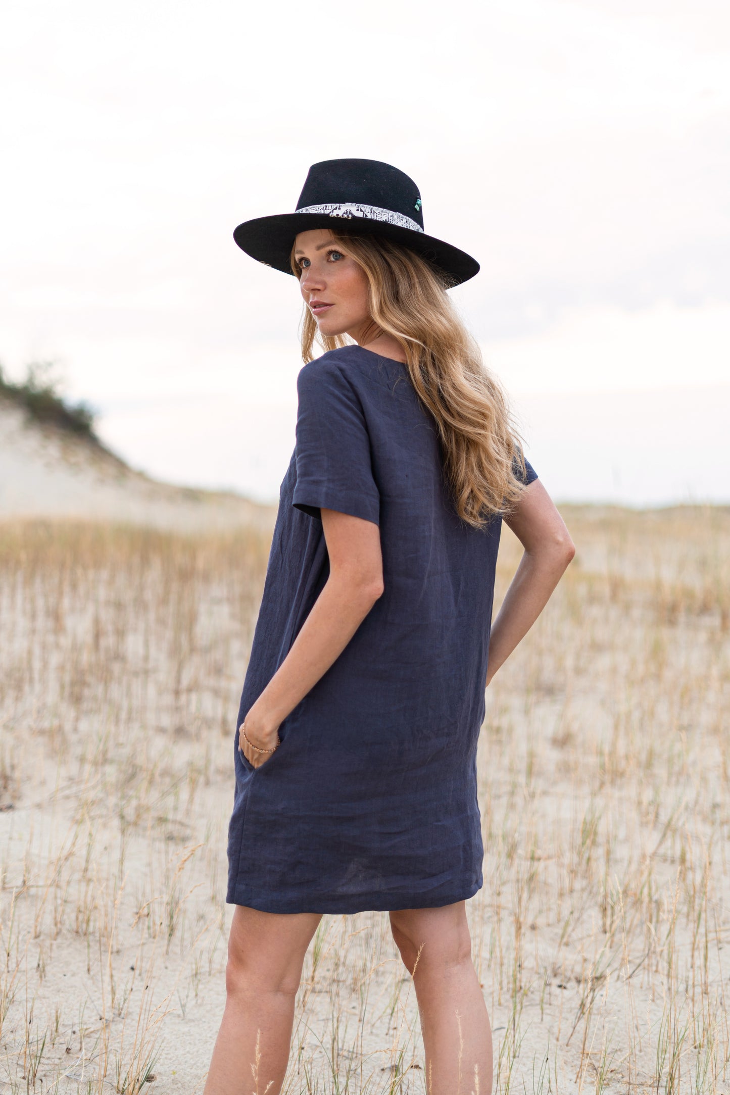 Graphite grey linen dress outdoor side view showing a-line shape, handmade linen dress slow fashion