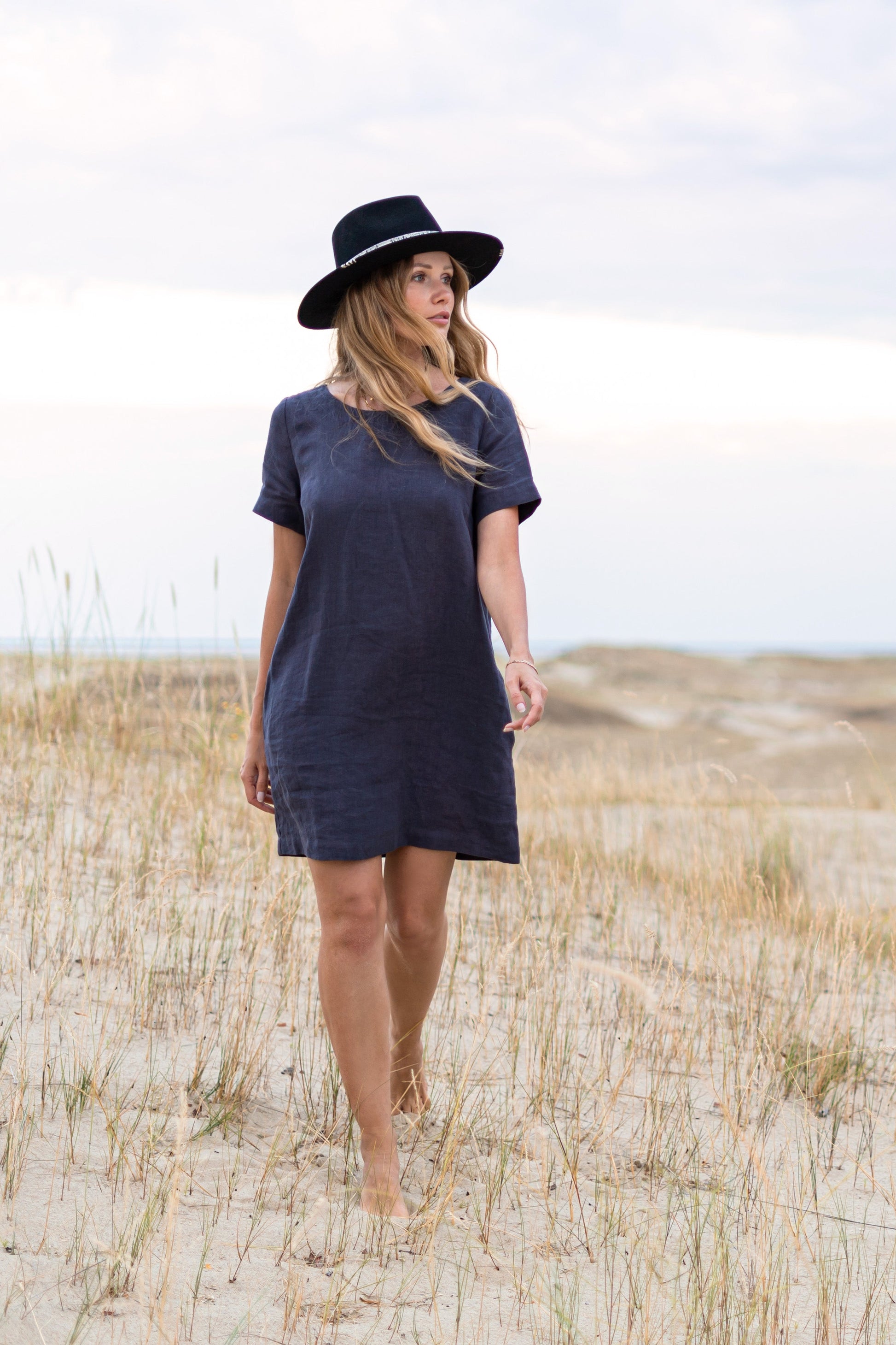 Graphite grey linen dress outdoor setting showing short sleeves and comfortable fit, handmade linen dress slow fashion